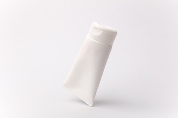 Floating cream tube on a white background