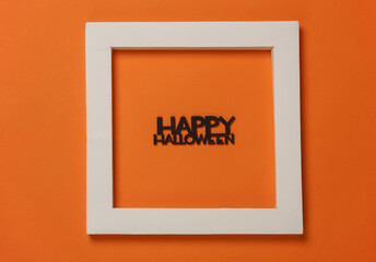 Рфззн Halloween word with white frame on orange background.