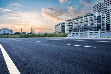 New asphalt road and cityscape background