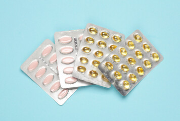 Blisters of tablets and pills on a blue background