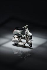 Photo of an old miniature Vespa which is also called a scooter. Photographed with a not so bright...