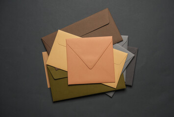 Stack of colored envelopes on dark gray background