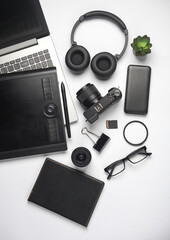 Modern gadgets on a white background Camera, power bank, headphones and accessories. Flat lay. Top view