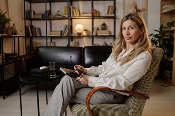 Caucasian female mental health specialist posing at her workplace in office with modern interior