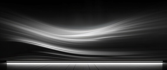 An abstract background in black, dark gray, silver, and white, featuring undulating waves and a subtle ombre gradient.