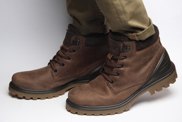 Male legs in warm winter boots on a white background. Army style