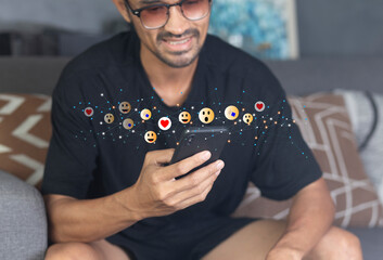 Social media concept with happy young man using smartphone with giving icon rating during watching...
