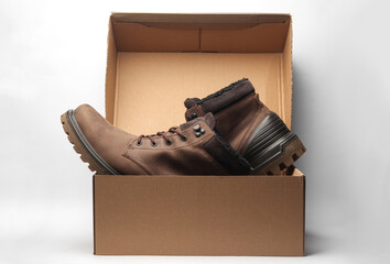 New men's winter boots in box on white background