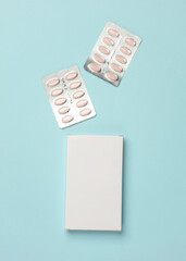 Box of pills on blue background