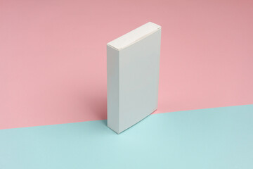 White Box of pills on blue pink background