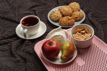 Breakfast in bed. Food on a dark blanket. Top view