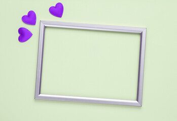 Empty Frame with hearts on green background. Romantic, love concept