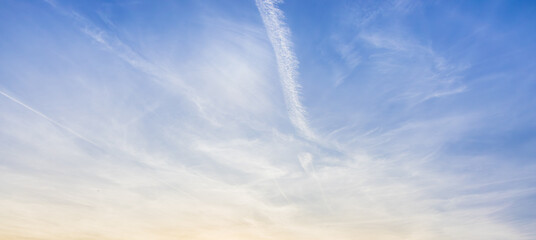 White clouds spread thinly in the blue sky - artificial cloud, contrail