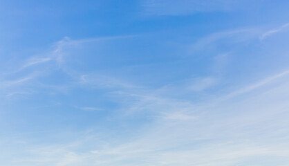White clouds spread thinly in the blue sky - obrazy, fototapety, plakaty