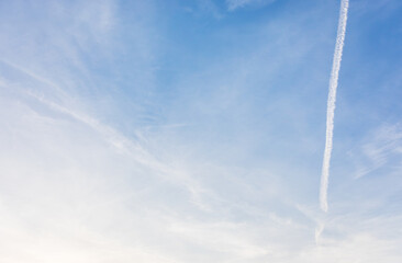 White clouds spread thinly in the blue sky - artificial cloud, contrail