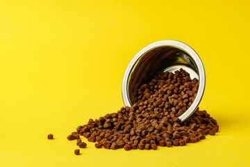 Cat food on yellow background studio shot