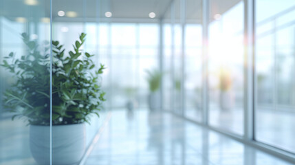 Modern office interior with large windows and plants. Blurred background.