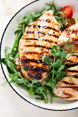 Roasted chicken breast, fillet and fresh vegetable salad.