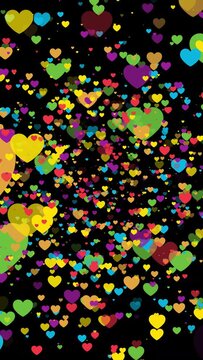 Vertical video valentine's day flying colorful love hearts particles animation loop on transparent background. LGBTQ pride month colorful hearts animation. High-quality 4K footage.
