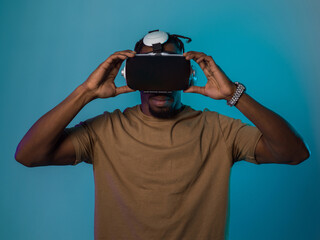 In a futuristic visual, an African American man stands isolated against a striking blue backdrop,...