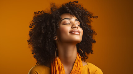African woman curly hair is smiling and eyes closed in brown studio background