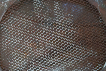 metal texture with wire mesh netting began to rust steel for background