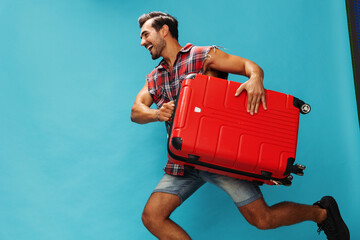 Suitcase man traveler happy guy trip studio journey baggage flight travel vacation background...