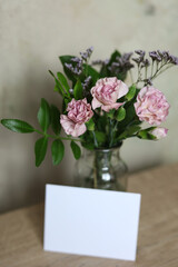 card mockup with white flowers on a table