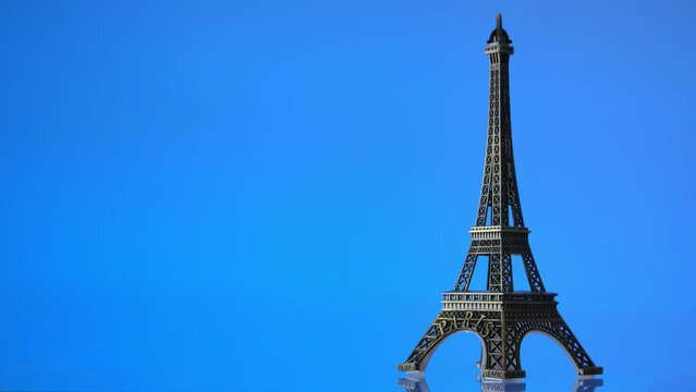 The Eiffel Tower against colorful backgrounds. Miniature replica of the Eiffel tower against colorful backgrounds. Paris 2024 Summer Olympics.