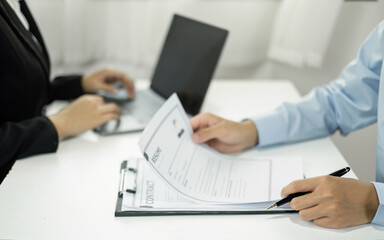 Business people hold a resume and talk to job applicants for job interviews about careers and Their personal history in the company. Recruitment concepts