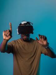 Immersed in a digital realm, an African American man navigates the virtual landscape with a VR...