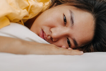 Asian woman sleeping deeply in the apartment as she tired and sick.