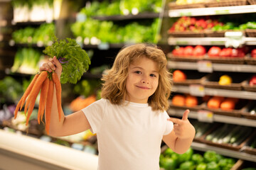Child choosing vegetables in supermarket store. Kids in food supermarket. Sales, discounts in food supermarket store and shopping. Kid in market bay vegetables and fruits. Child buy in supermarket.