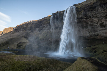 view of the shaded waterfall complex Seljalandsdoss, Iceland
