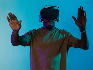 Immersed in a digital realm, an African American man navigates the virtual landscape with a VR...
