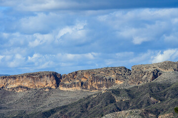 Fototapeta premium Majestic Cliff Faces Under a Dynamic Sky