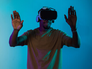 Immersed in a digital realm, an African American man navigates the virtual landscape with a VR...