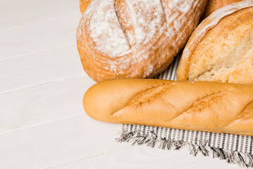 Homemade natural breads. Different kinds of fresh bread as background, perspective view with copy space