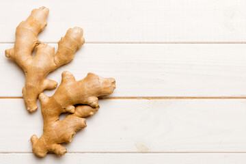 Finely dry Ginger powder in bowl with green leaves isolated on colored background. top view flat lay