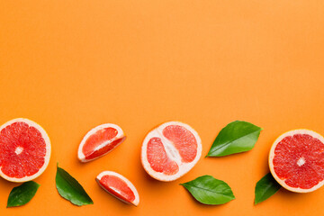 fresh Fruit grapefruit with Juicy grapefruit slices on colored background. Top view. Copy Space. creative summer concept. Half of citrus in minimal flat lay with copy space