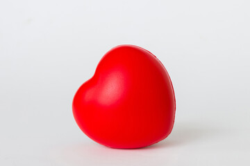 gift box with red bow and red heart on colored background. Perspective view. Flat lay