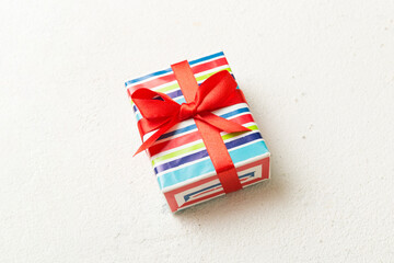 Wrapped christmas or other holiday handmade present in paper with colored ribbon. Present box,...