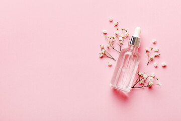 Fancy healthcare bottles for serum, micellar, tonic, toner, lotion, water and cream with gypsophila branch. Natural oranic spa cosmetics concept. Mockup, template, Top view