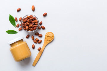 Bowl of peanut butter and peanuts on table background. top view with copy space. Creamy peanut pasta in small bowl