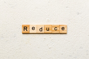 reduce word written on wood block. reduce text on cement table for your desing, concept