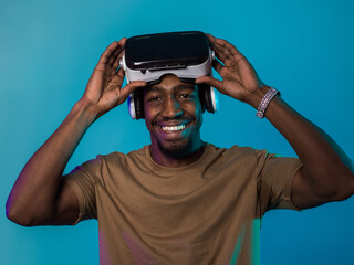 In a futuristic visual, an African American man stands isolated against a striking blue backdrop,...