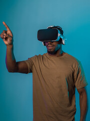 Immersed in a digital realm, an African American man navigates the virtual landscape with a VR...