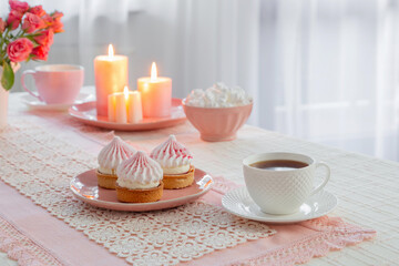 cup of coffee with dessert and roses on table