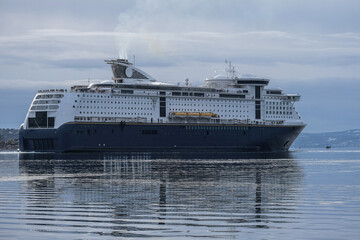 Color passenger freighter roll on roll off ro-ro pax cruise ferry Fantasy Magic in port of Oslo, Norway with city skyline, yachts, marine vessels and harbor infrastructure