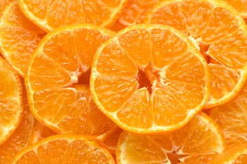 juicy and appetizing tangerines cut into circles as a food background 6